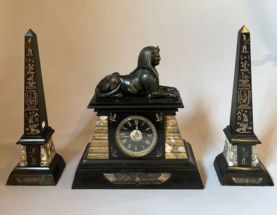 a statue of a lion and a clock on a table