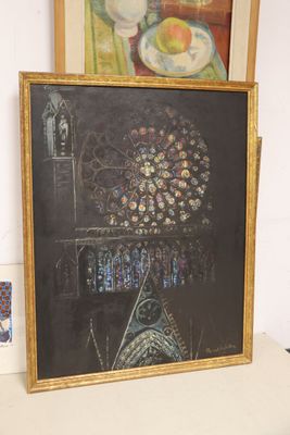 a picture of a painting on a table next to a picture of a woman