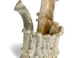 an image of a vase with a handle and a piece of wood in it