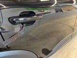 a close up of a car door handle with a sticker on it