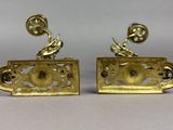 a pair of gold plated earrings with a bird and flower design