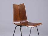 a wooden chair with black legs and a brown seat