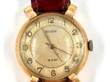an image of a close up of a wrist watch on a white surface