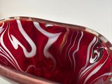 a red and white bowl sitting on a table