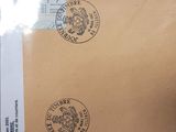 a brown envelope with stamps on it sitting on a table