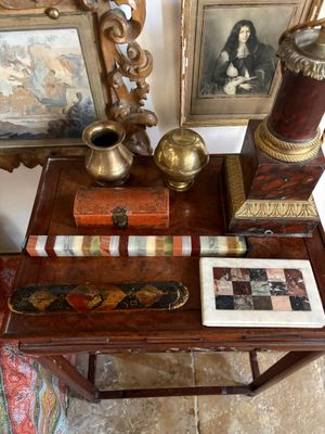 a small table with pictures and a vase on it