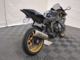 a motorcycle that is parked on a checkered floor