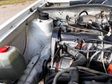 a car engine with its hood open on the side of the road