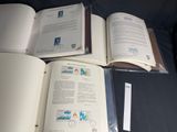 three open books sitting on a black surface