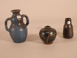 three vases sitting next to each other on a table