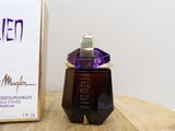 an image of a bottle of perfume sitting on top of a wooden table