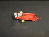 a red toy truck with a can of soda in the back