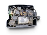 a black container filled with assorted items on a white surface