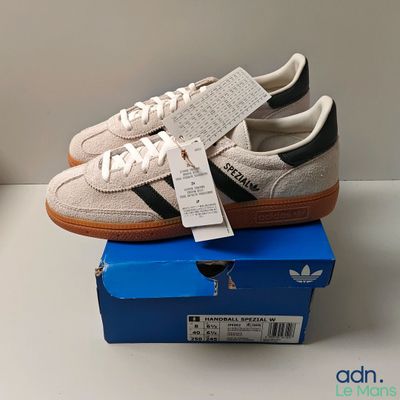 adidas gazelle trainers in white and black on top of a blue box