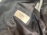 the back of a jacket with a label on it sitting on a chair