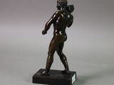 bronze statue of a man holding a baseball bat on a marble base