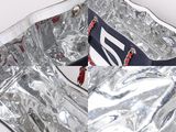 a silver bag with a red and white stripe on it