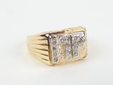 a close up of a gold ring with two diamonds on it