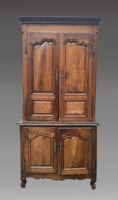 an old wooden cabinet with two doors and two drawers