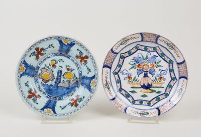 pair of blue and white plates with birds and flowers on them