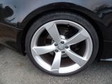 a close up of a car ' s wheel on the street