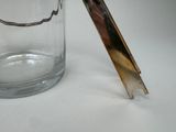 a glass jar with a spoon in it and a spoon sticking out of it