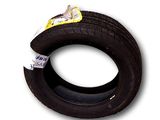 a close up of a tire on a white background with a yellow tag