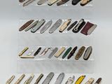 many different types of knives on display in a display case