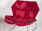 pair of red origami lounge chairs on chrome steel legs