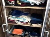 a metal cabinet filled with lots of clothes and other items