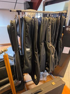 a suit case that has a bunch of jackets hanging on it