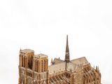a wooden model of a cathedral on a white surface