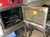 a dirty oven in the middle of a kitchen