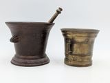 two antique brass mortars and a mortar stick