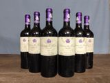 six bottles of wine sitting on top of a wooden table
