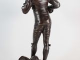 bronze statue of a man with a gun on a base