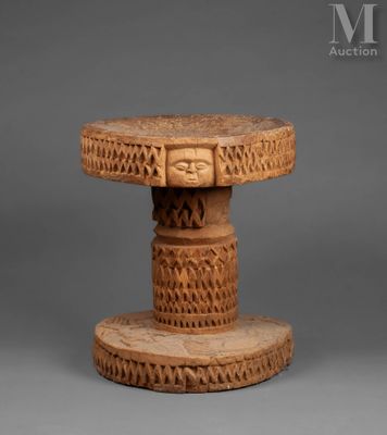 a small wooden table with carvings on top of it