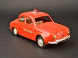 a red toy car with a red light on top of it