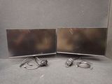two monitors that are sitting on a table