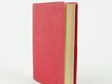 a red book that is open on a white surface