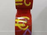 a red sculpture with a yellow and red design on it