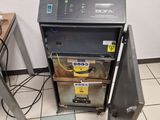 a machine that is sitting on the floor next to a red chair