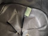 a close up of a black leather bag with a tag on it