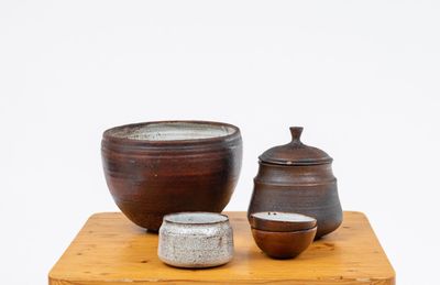 three bowls and a bowl on a small wooden table
