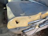 a dirty seat in the back of a car with a hole in it