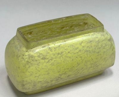 a green vase that is sitting on a table