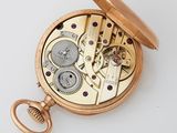 a gold pocket watch with a chain attached to it