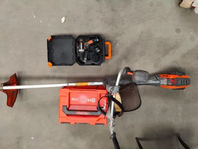 a picture of a corded edger and a tool box on the ground