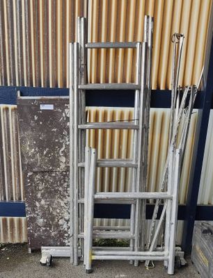 a lot of ladders that are outside of a building