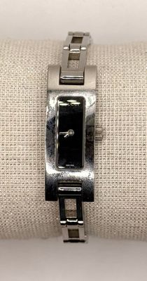 a close up of a watch on a napkin